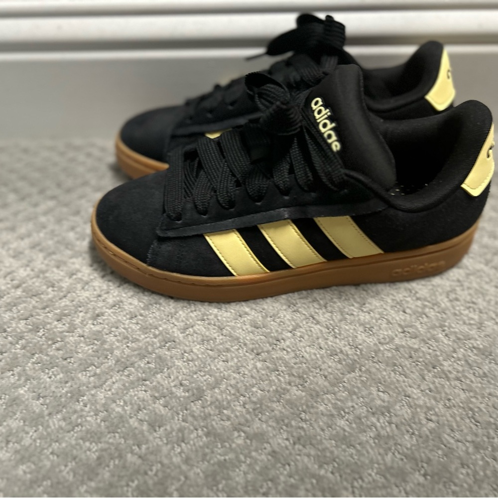 Adidas Black and Gold Athletic Shoes with Signature Stripes